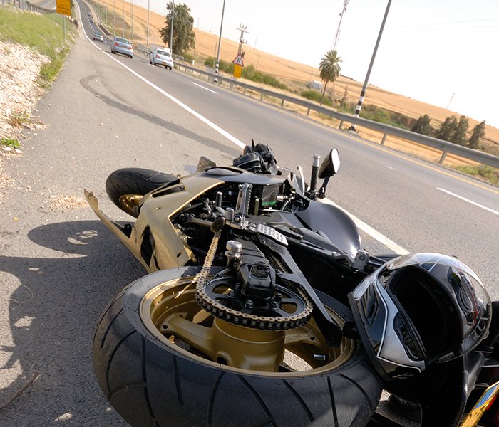 motorcycle laying on Queens NY road after a crash