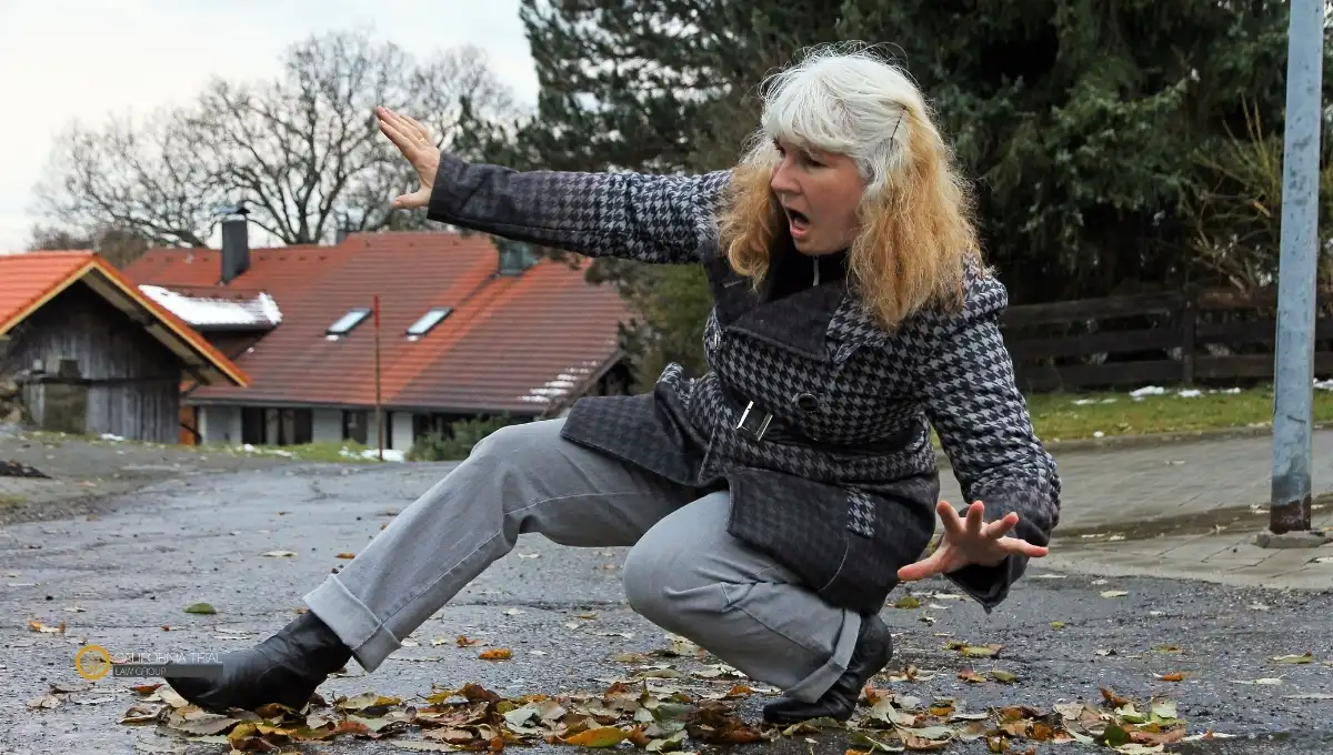 A woman fell down on the side of the road